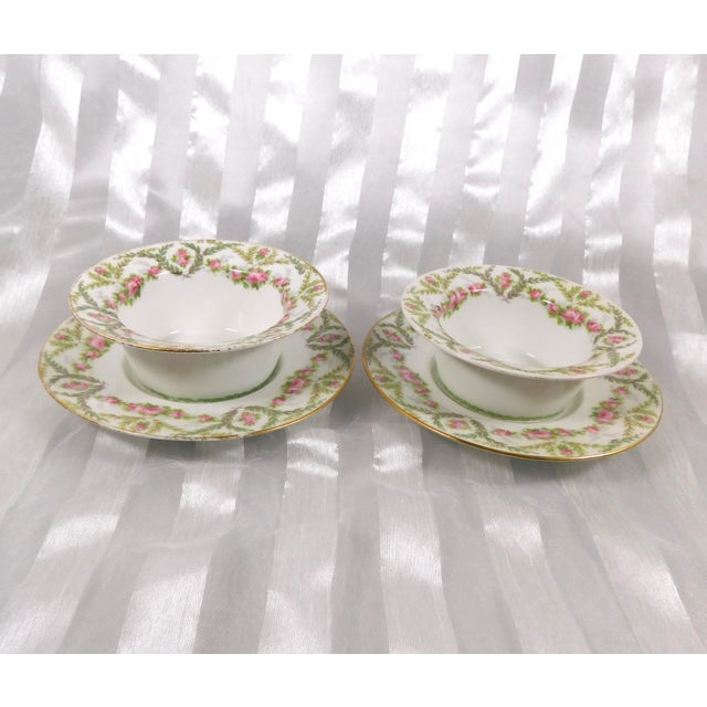 This is a set of two Jean Pouyat Limoges ramekin dishes and underplates in an unknown pattern. The dishes are white with a...