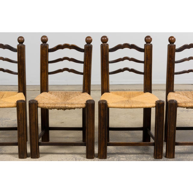 French provincial ladder-back dining chairs sourced in Provence, dating to the late 19th century. The chairs are...