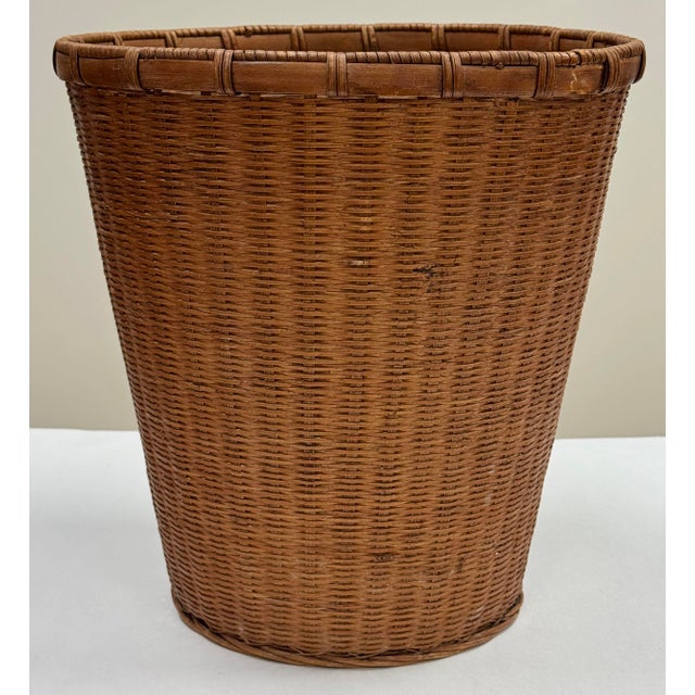 Vintage woven wicker waste basket. Age wear. Crack to rattan edging as shown. Not perfectly round.