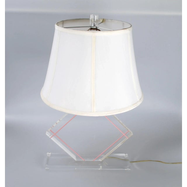 Lucite-and-chrome table lamp with harp and finial. Wired for the U.S. and uses a 60W-max bulb. Shade is NOT included....