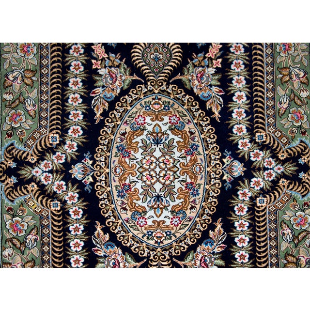 A lovely late 20th century Persian Rum rug with an intensely woven floral medallion with a lively energy, and surrounded...