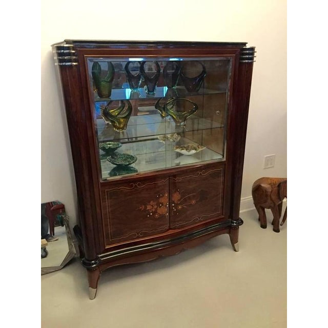 Stunning French Art Deco vitrine or dry bar. Having beautiful mother-of-pearl inlay with gorgeous marquetry. With black...