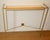 Gold-patinated metal frame with a sycamore shelf. Secure with two concealed screws. Once the shelf is in place, screw the...