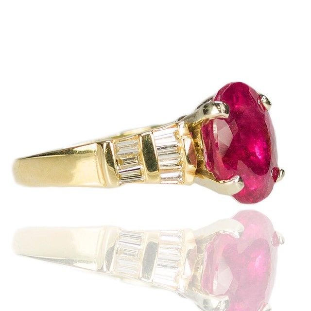14k Ring set with 1 Rubellite Tourmaline weighing 5.13 carats and 14 baguette diamonds weighing approximately 0.50 carats....