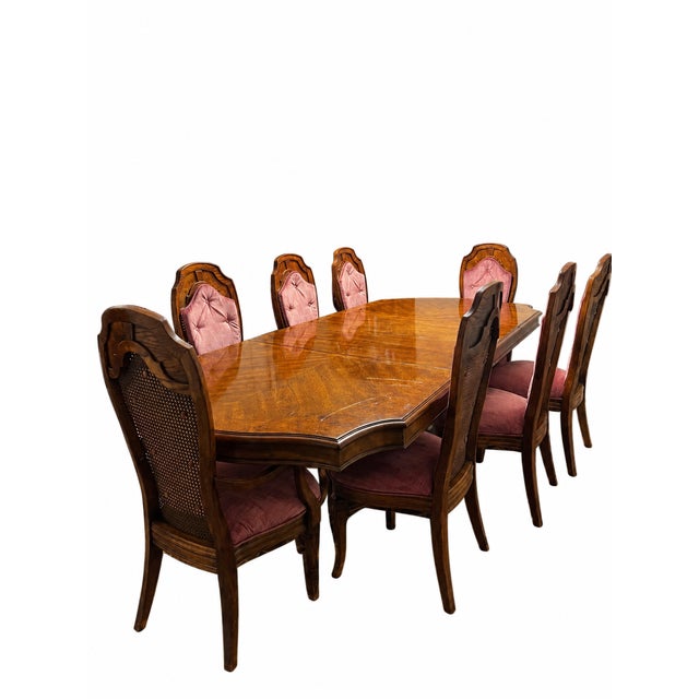 An elegant nine-piece dining set featuring a richly figured wood dining table and eight coordinating high-back chairs. The...