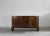 A mid-century sideboard with structure in walnut veneer with brass details, the sideboard presents three doors and six...