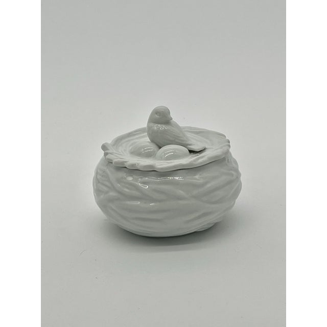 Lovely trinket box in the shape of a bird’s nest. The outer box has a woven pattern like a nest and a tiny bird with its...