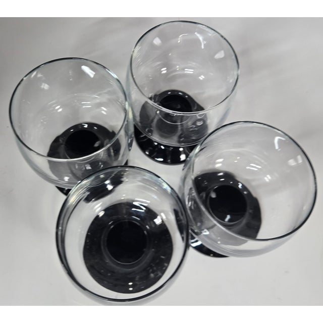 Slick, liquid black stems with a chunky modern vibe in a compact size.