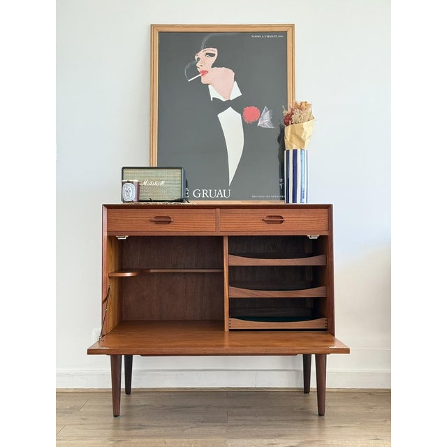 Elegant Mid-Century Modern teak bar, designed by Ejvind A. Johansson in the 1960s, featuring a sleek Scandinavian design...
