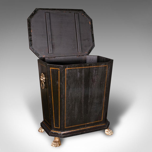This is an antique fireside store. An English, ebonised pine and brass coal or log bin in Aesthetic Period taste, dating...