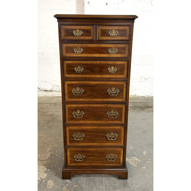 This Drexel 18th Century Collection lingerie chest features a tall, narrow profile with a series of graduated drawers,...