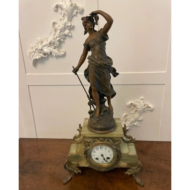 Antique French onyx and clock having a quality painted dial, original hands and eight day movement striking on the hour...