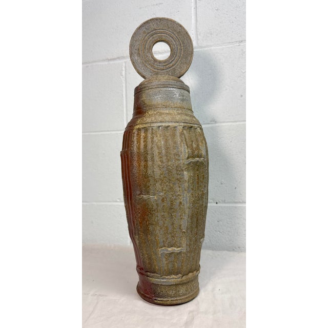 This large handmade signed Lewis pottery lidded vase/urn is a unique brutalist sculpture statue made of pottery. Made in...