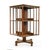An elegant antique English rotating bookcase in wood, square in shape, resting on a central pivoting base allowing easy...
