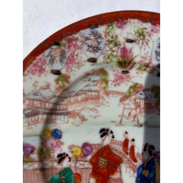 An exquisite vintage Japanese Kutani porcelain accent plate dating from the late Meiji period to the mid-20th century....
