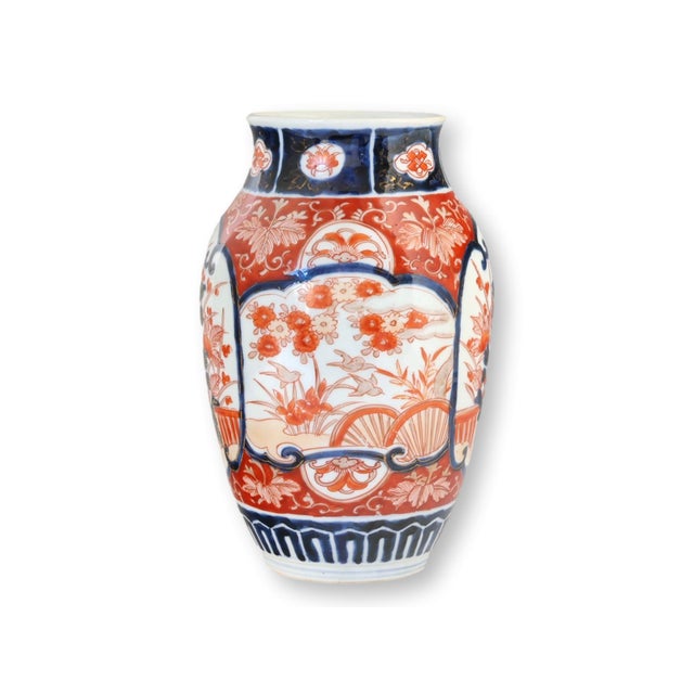 Antique Japanese Imari porcelain vase, Meiji period, circa 1880. This vibrant hand-painted example displays bold cobalt...