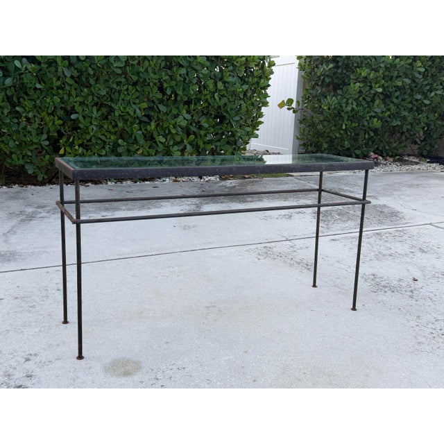 Vintage industrial modern console table featuring a streamlined iron frame with a beautifully aged, naturally oxidized...