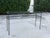 Vintage industrial modern console table featuring a streamlined iron frame with a beautifully aged, naturally oxidized...