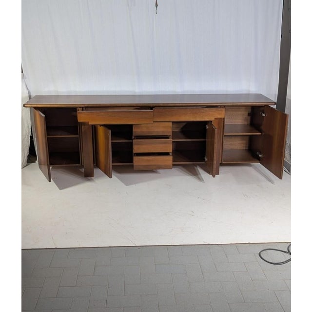 Add a touch of timeless elegance to your home with the mid-century walnut sideboard, model Sapporo, created by famous...