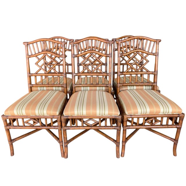Set of six rattan dining chairs by Lexington Home Brands, featuring classic Palm Beach–style fretwork backs. The geometric...