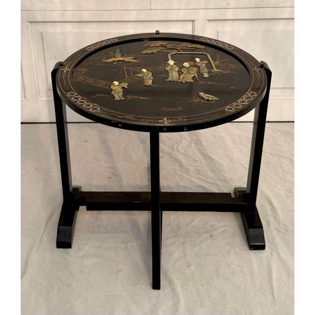 Here is a beautiful vintage Asian black lacquer folding tray table, made in the mid-20th century, likely 1950s–1970s,...