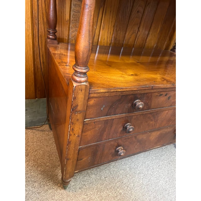 This is an exceptional piece dating between 1820 and 1860, English Regency mahogany three tiered with three drawer etegere...