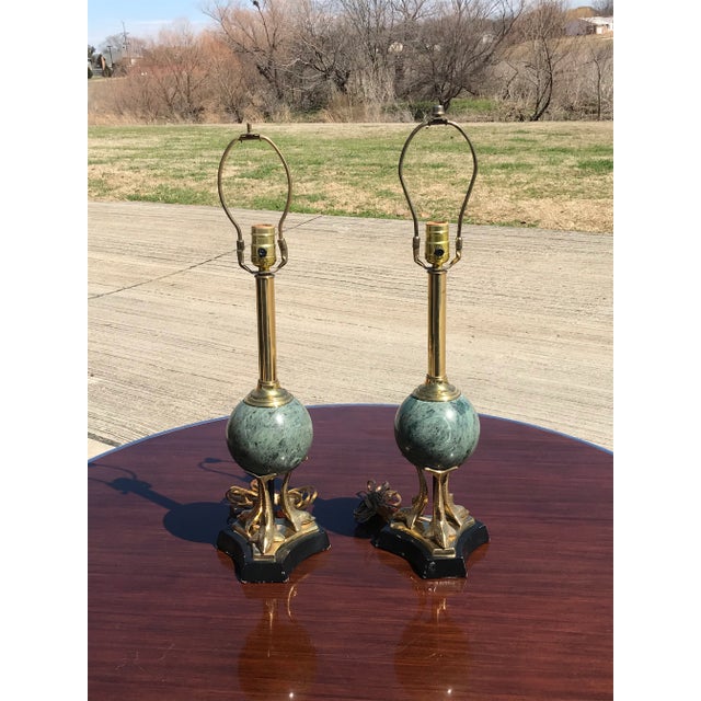 Vintage triple brass sculptural dolphin supporting a green marble sphere table lamp a pair. Each lamp takes a standard...