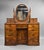 A fine quality burr walnut dressing table of elegant proportions, featuring a striking oval mirror flanked by decorative...