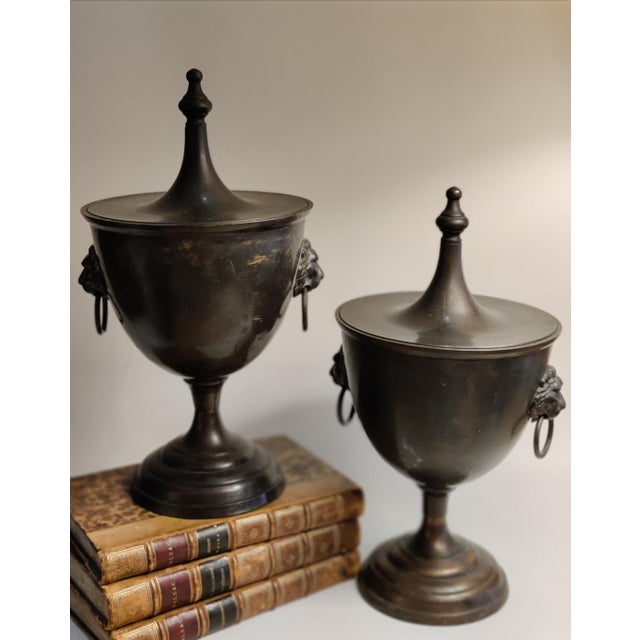 For your consideration . . . A rare vintage pair of gorgeous Chestnut Urns with lion head ring handles. Each urn vase has...
