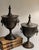 For your consideration . . . A rare vintage pair of gorgeous Chestnut Urns with lion head ring handles. Each urn vase has...