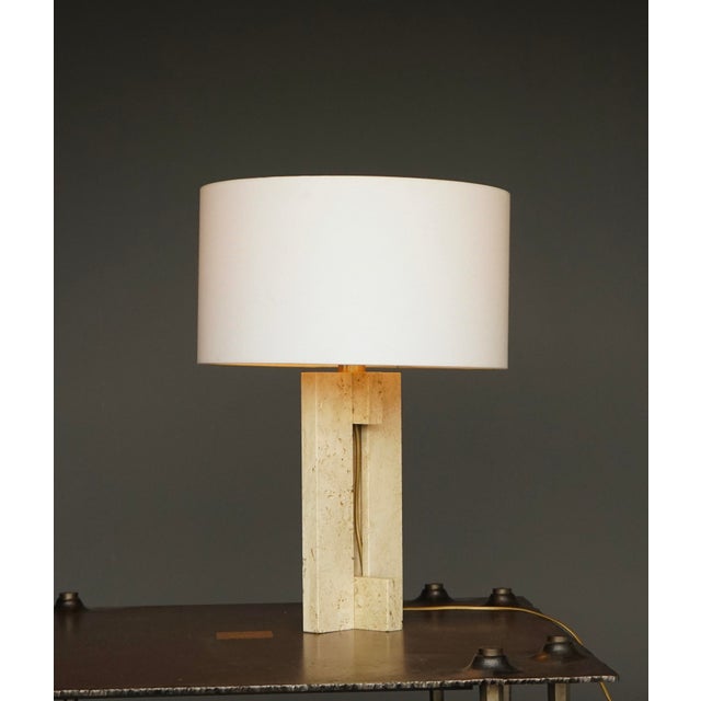 A stylish Italian table lamp with solid travertine base and a brass fitting. Unmarked it is very much in the style of...