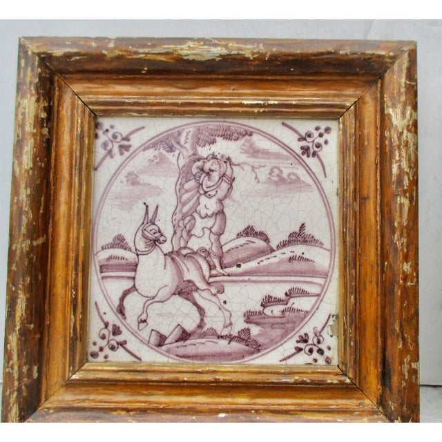 A gilt wood-framed pair of Delt ceramic tiles, glazed in manganese color, purple to brown colors. Circa 1750s Dutch scenes...