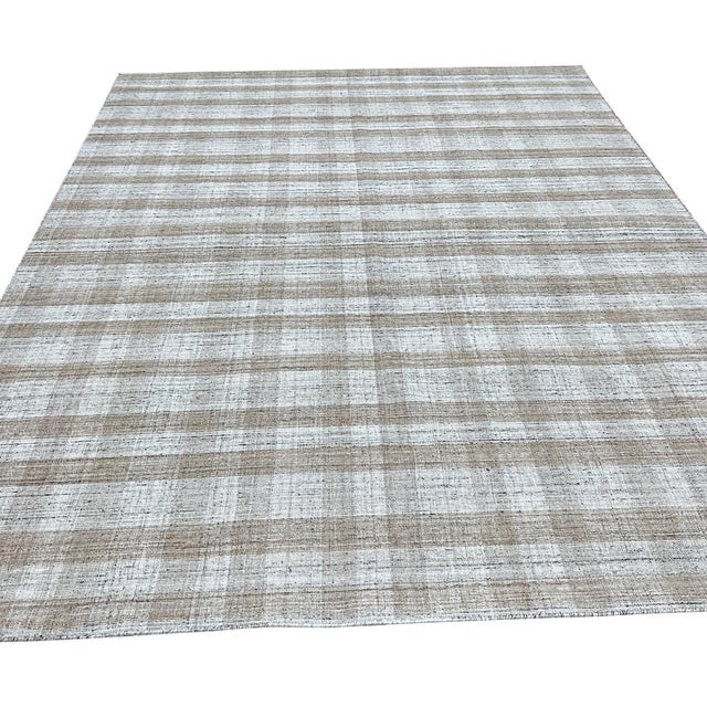 Serene Chloe Beige Flatweave Wool Rug, Country of Origin: India. This contemporary piece offers a sophisticated...