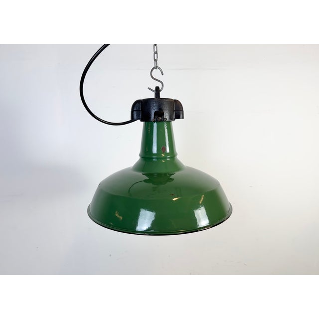Industrial green enamel factory pendant light made in United States during the 1960s. White enamel inside the shade. Iron...