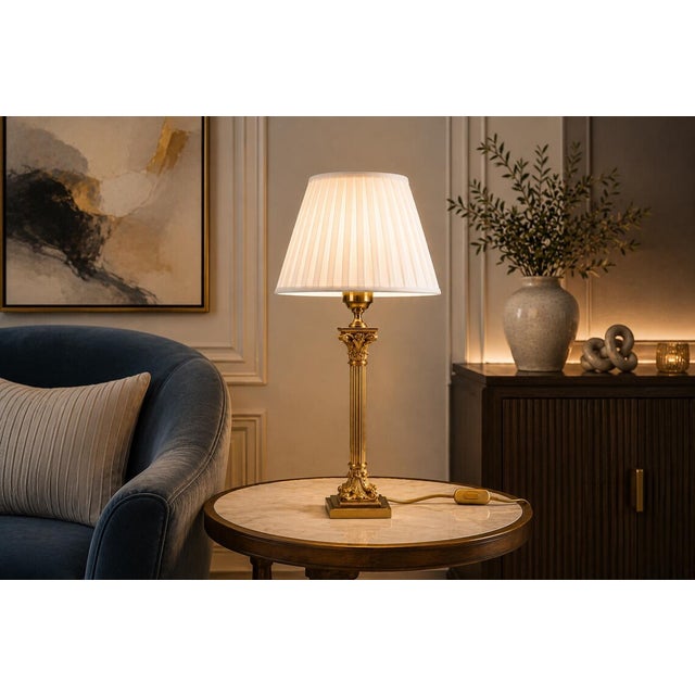 A tall and elegant vintage table lamp inspired by classical empire and neoclassical design, featuring a polished brass...