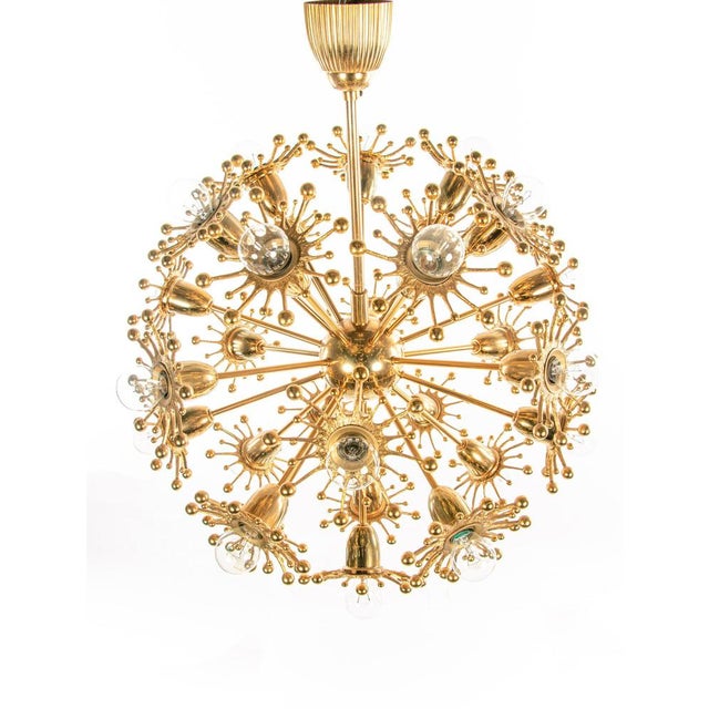 Large 29 lights chandelier with gold-plated pistil flowers. Designed by christoph palme. The lamp has an incomparable...
