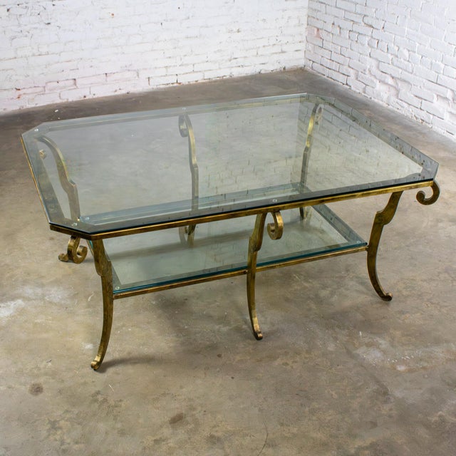 Handsome vintage Hollywood Regency to Neoclassical style monumental sized coffee table composed of a gilded welded steel...