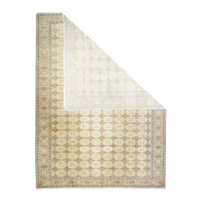 This eastern Turkish carpet shows a small, allover gul pattern on a sand ground. Sand-straw border of additional guls....