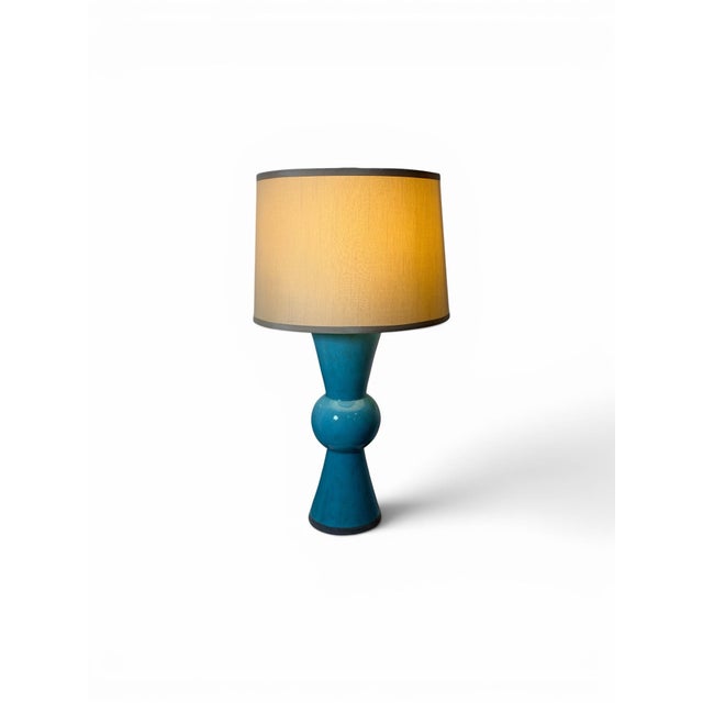 The Upbeat Teal Table Lamp is mod in style - Retails for $500. The shapely terracotta body has a center ball with cones...
