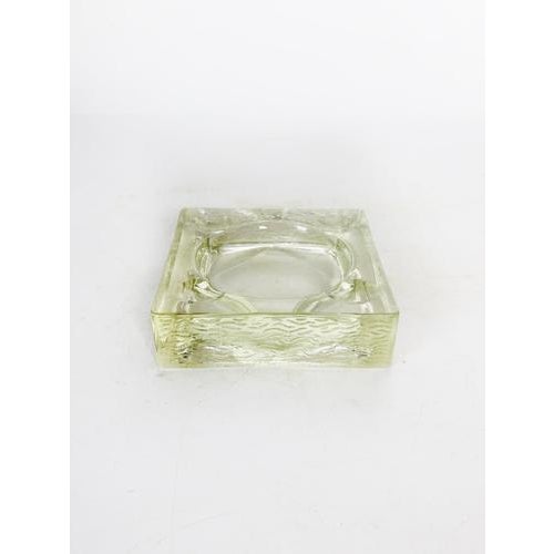 Square molded glass ashtray, France, circa 1940, in the Art Deco style. Made of thick, slightly green-tinted glass, it...