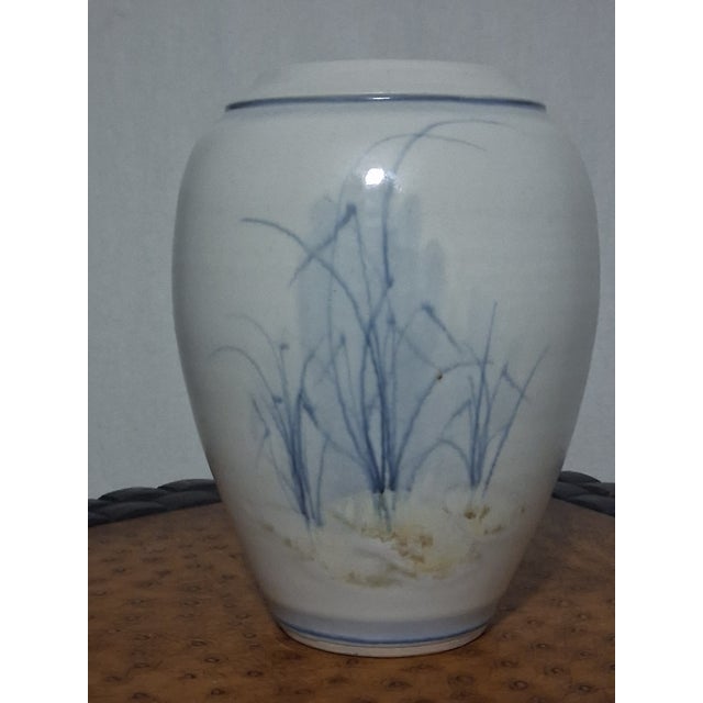 Mid-20th Century (Circa 1960s-1970s) Product Description: This elegant Mid-Century Studio Pottery vase features a serene,...