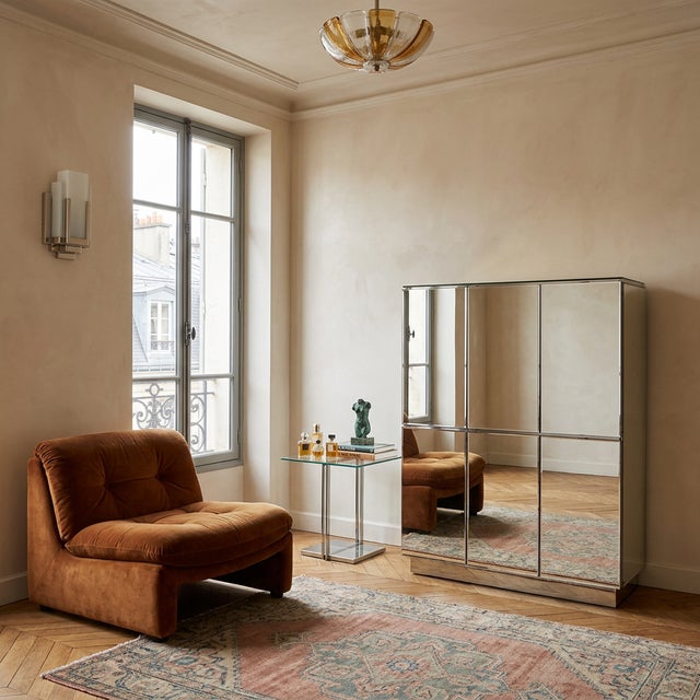This two-piece, Art Deco inspired cabinet features mirrored glass construction, offering ample storage and versatility....