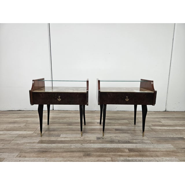 An elegant pair of vintage mahogany nightstands dating back to the 1960s, featuring refined lines and a unique combination...