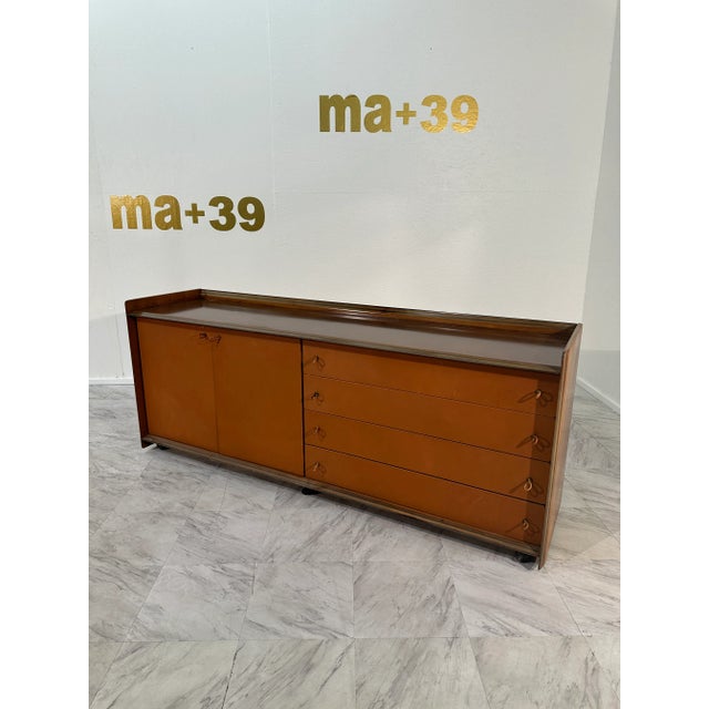 Designed by Afra and Tobia Scarpa for the Artona line by Maxalto, this 1975 sideboard features a walnut frame with a...