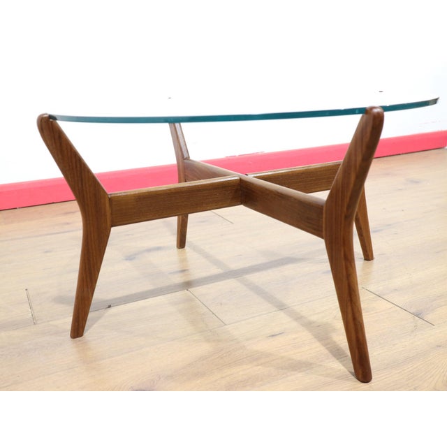 This Mid Century Vintage Teak and Glass Coffee Table embodies true mid century style, showcasing a beautiful is century...