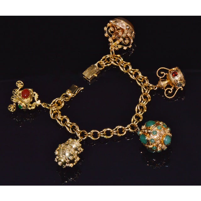 Vintage Portuguese and Italian Etruscan Revival solid gold multigem fob charm bracelet. The bracelet is crafted in solid...