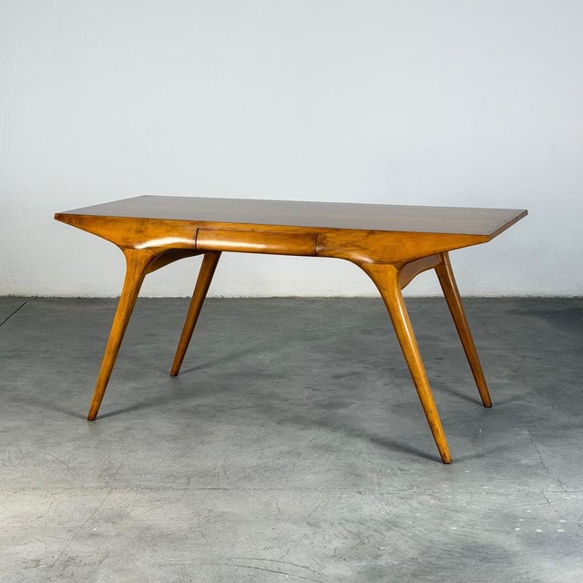 A rare and highly sculptural desk by carlo de carli, where structure and form resolve into a single, continuous gesture....