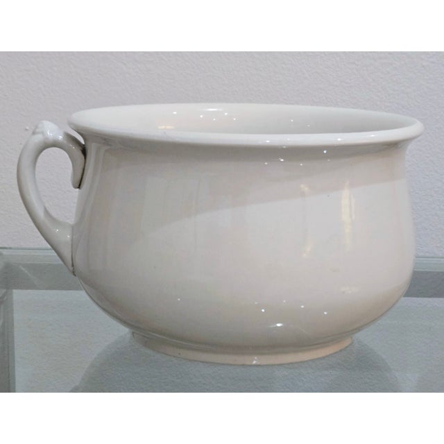 This classic white ironstone chamber pot bowl was produced by Homer Laughlin in the United States, circa 1920s, and...