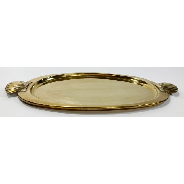 Lovely vintage brass oval shaped tray with clam shell shaped handles to either end. Wonderful patina.