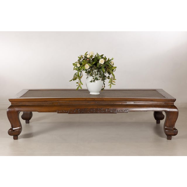 This antique Chinese opium bed has been thoughtfully repurposed as a substantial coffee table, retaining the sculptural...